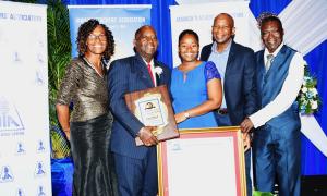 Miss Dorane Dixon (centre) shares the proud moment with her father, Mr. Doran Dixon (second left) who was named the 55th recipient of the Jamaica Teachers' Association Roll of Honour Award on November 20. They are joined by (from left:): Pastor Doreen Williams of the Church of God of Prophecy in Church Pen, Old Harbour; Mr. Desmond Rose, who is Mr. Dixon's lifelong friend; and Deacon Gayford Williams, also from the Church of God of Prophecy.