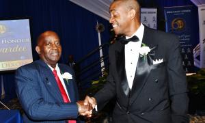 JTA Roll of Honour Awardee, Mr. Doran Dixon (left) is congratulated by Attorney-at-Law, Mr. Andre Earle. The occasion was the November 20 Presentation Ceremony at the Jamaica Pegasus Hotel.