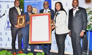 Mr. Doran Dixon ( second left) is the "man of the moment" after receiving the 2024 Jamaica Teachers' Association Roll of Honour Award. He is warmly congratulated by (from left): Mr. Mark Smith, JTA President; The Hon. Ian Forbes, Custos of St. Andrew, who represented Governor General and Patron of the Award, Sir Patrick Allen; Dr. Kasan Troupe, Permanent Secretary in the Ministry of Education, Skills, Youth and Information; and Dr. Mark Nicely, JTA Secretary General.