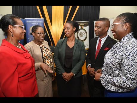 From left: Dr Glenda Prescod, of The Mico University College Alumni Association (MOSA); Prudence Burrell, acting manager, Jamaica Publishing House; Dr Tamika Benjamin, assistant chief education officer in the Ministry of Education; Dr Asburn Pinnock, president, The Mico University College; and Dr Ann-Marie Wilmott, lecturer and deputy director of Caribbean Centre for Educational Planning, have a chat at the event on Wednesday.